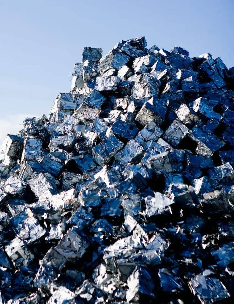 Heap of metal scrap against blue sky